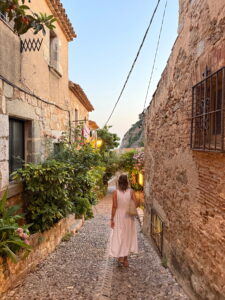 Frau in einer historischen Gasse der Altstadt von Tossa de Mar